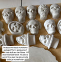 A collection of unpainted, light gray ceramic Day of the Dead decorative pieces, including sugar skulls, decorative holders, and a scalloped plate, arranged on brown kraft paper with a text overlay explaining the product selection.
